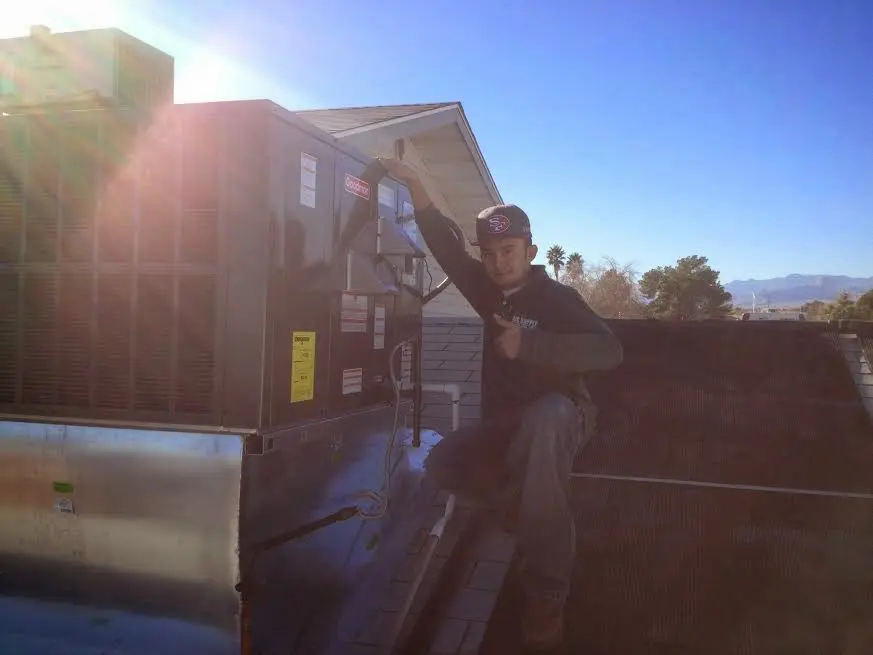 HVAC technician performing AC Tune-Up on a rooftop unit in Rolling Hills Estates